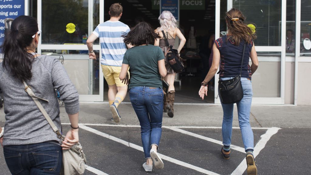 Leafly employees running into Goodwill for the Thrift Shop Cannabis Challenge