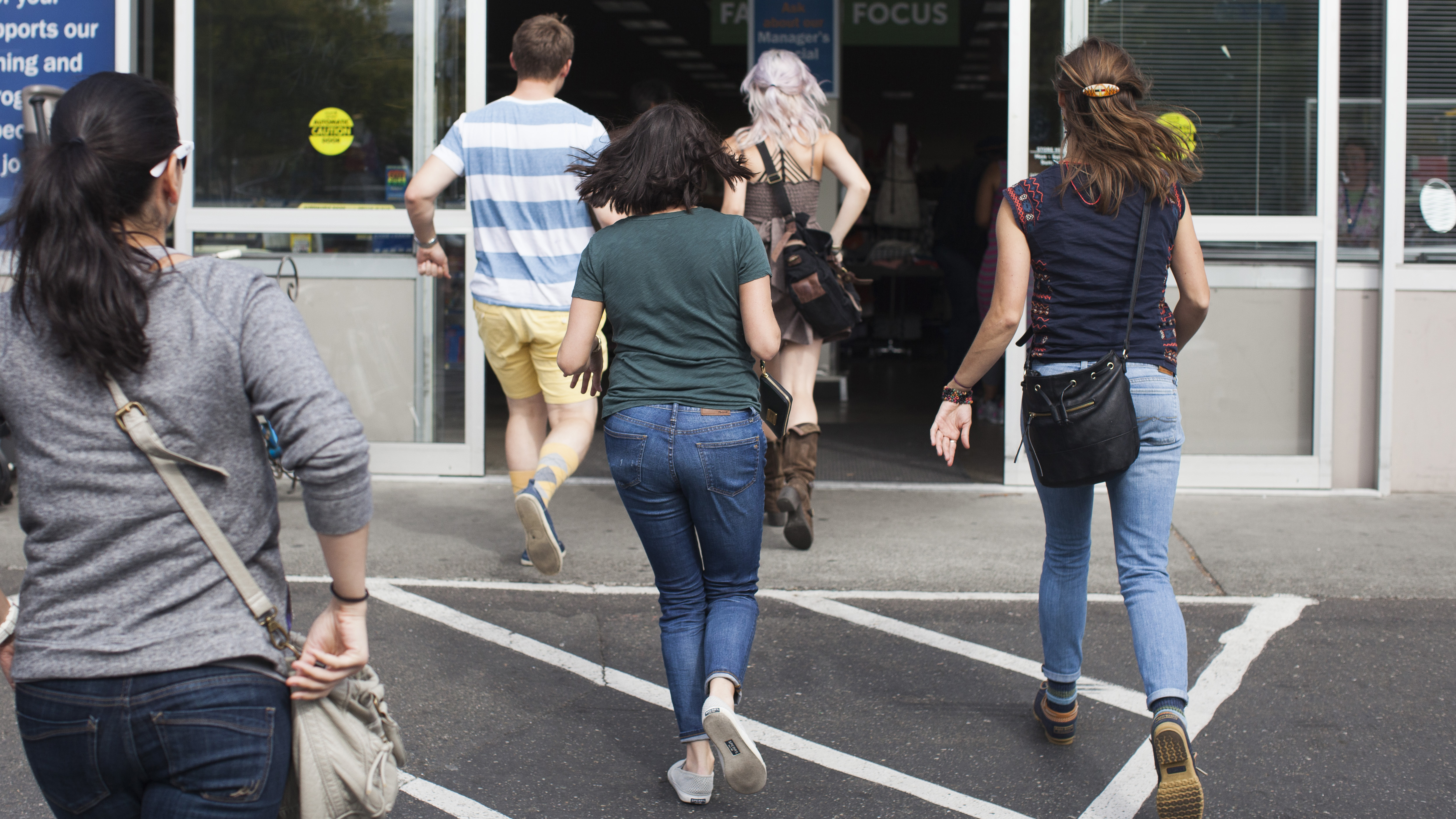 Leafly employees running into Goodwill for the Thrift Shop Cannabis Challenge