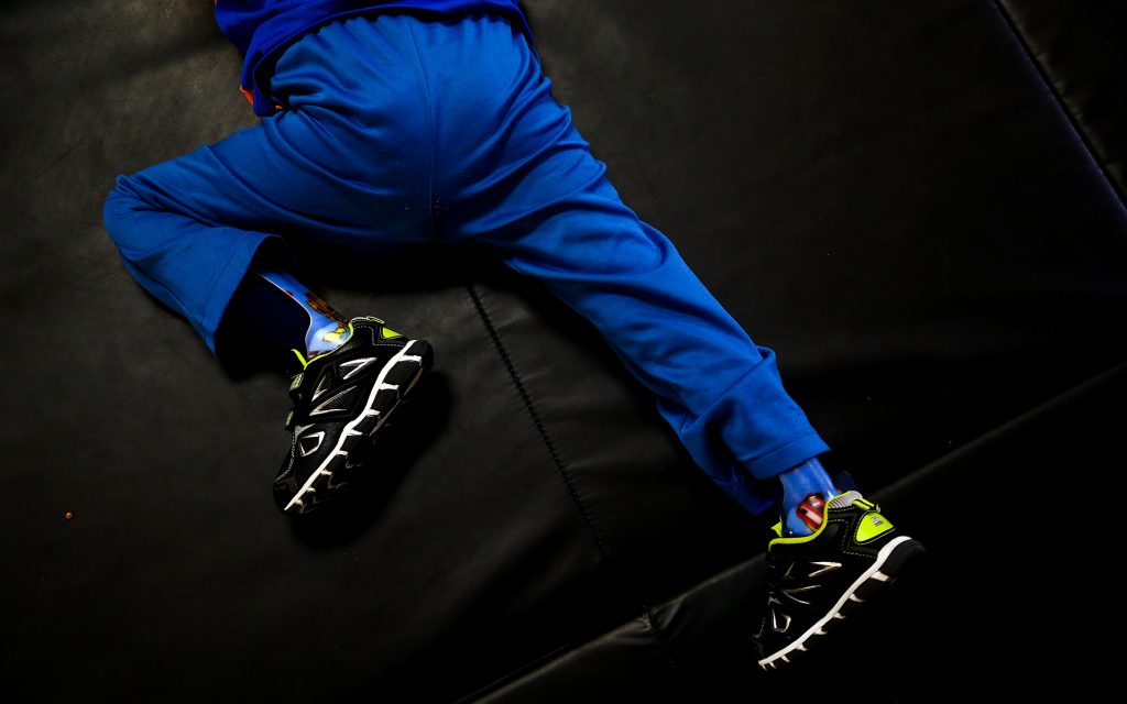 Bruno Stillo shuffles along the floor as he exercises his crawling during a therapy session at B&V Thera-Pro in Miami, FL on Friday, October 28, 2016. Before he began using medical marijuana, Bruno was mostly immobile. Since he started integrating it into his daily medication, his motor skills have improved and his epileptic seizures have drastically decreased. By Scott McIntyre