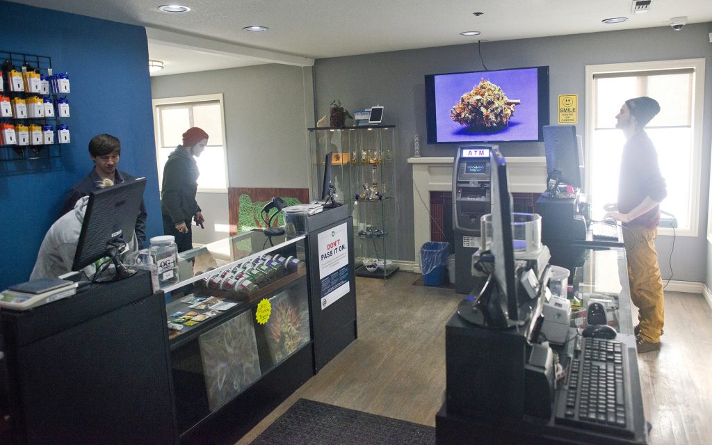 Budtenders restock cannabis products at Growing ReLeaf in Beaverton, Oregon