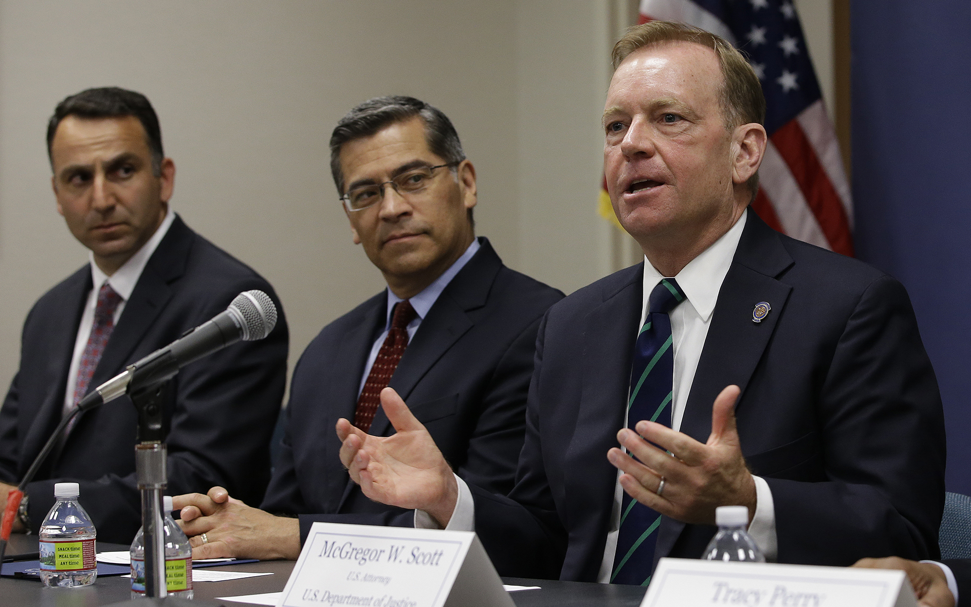 McGregor Scott, right, the United States Attorney for the Eastern District of California, flanked by California Attorney General Xavier Becerra, center, discusses an increase in the use of a banned pesticide at illegal marijuana farms hidden on public lands Tuesday, May 29, 2018, in Sacramento, Calif. Research by Mourad Gabriel, left, the executive director and senior ecologist at Integral Ecology Research Center, and his colleagues found the highly toxic pesticide Carbofuran, which can't legally be used in the Unites States, at 72 percent of grow sites last year, up 15 percent from 2012. (AP Photo/Rich Pedroncelli)