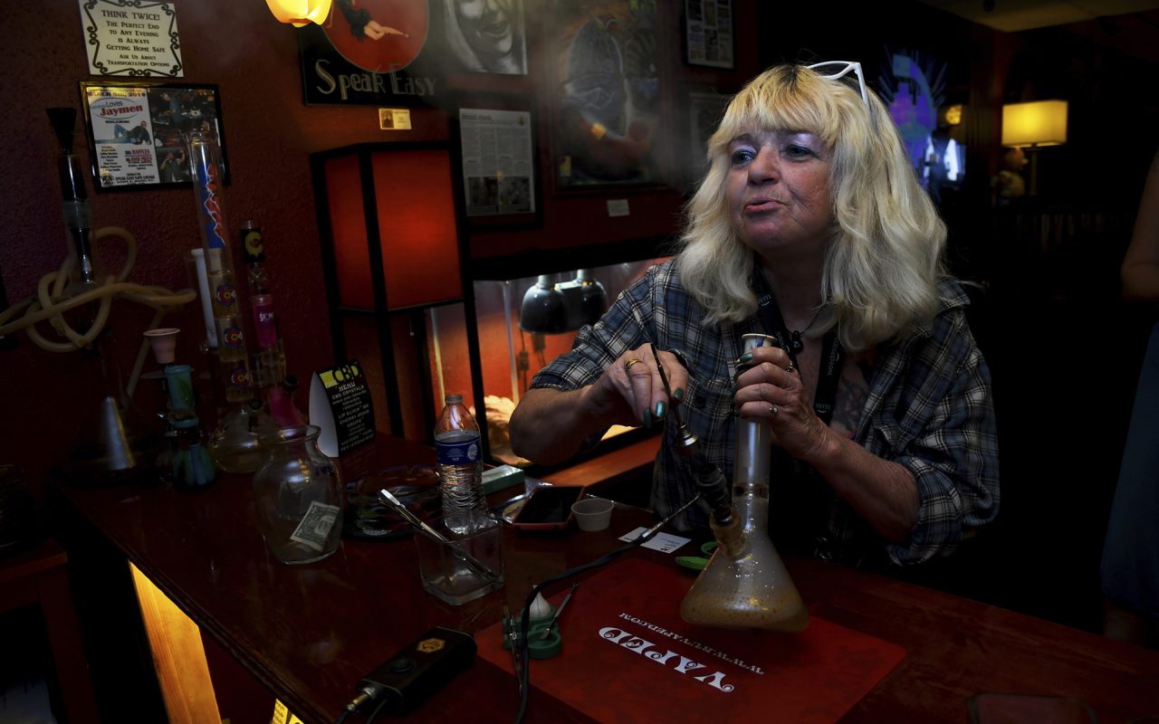 In this April, 12, 2017 file photo, Linda Wood smokes a concentrated form of marijuana called a "dab" at the Speakeasy Vape Lounge, one of the United States