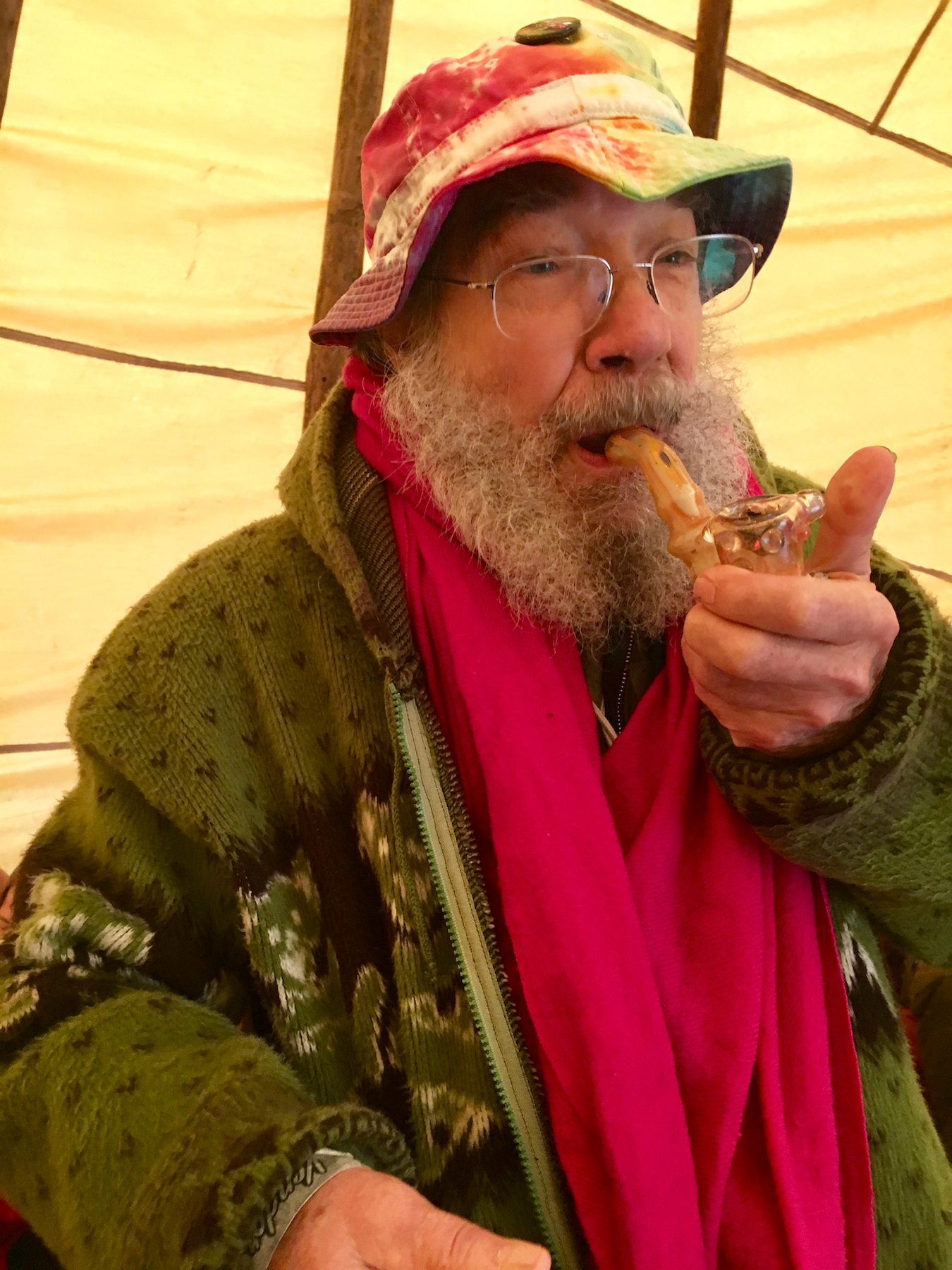 Borosilicate glass pipe pioneer Bob Snodgrass hits a piece made by his son in the Dragonfly Earth Medicine Tent Sunday. (David Downs/Leafly)