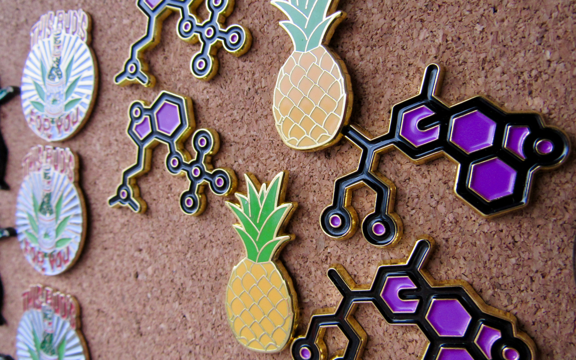 Hat pins in the shape of THC molecules and pineapples sold for $15 each. (David Downs/Leafly)
